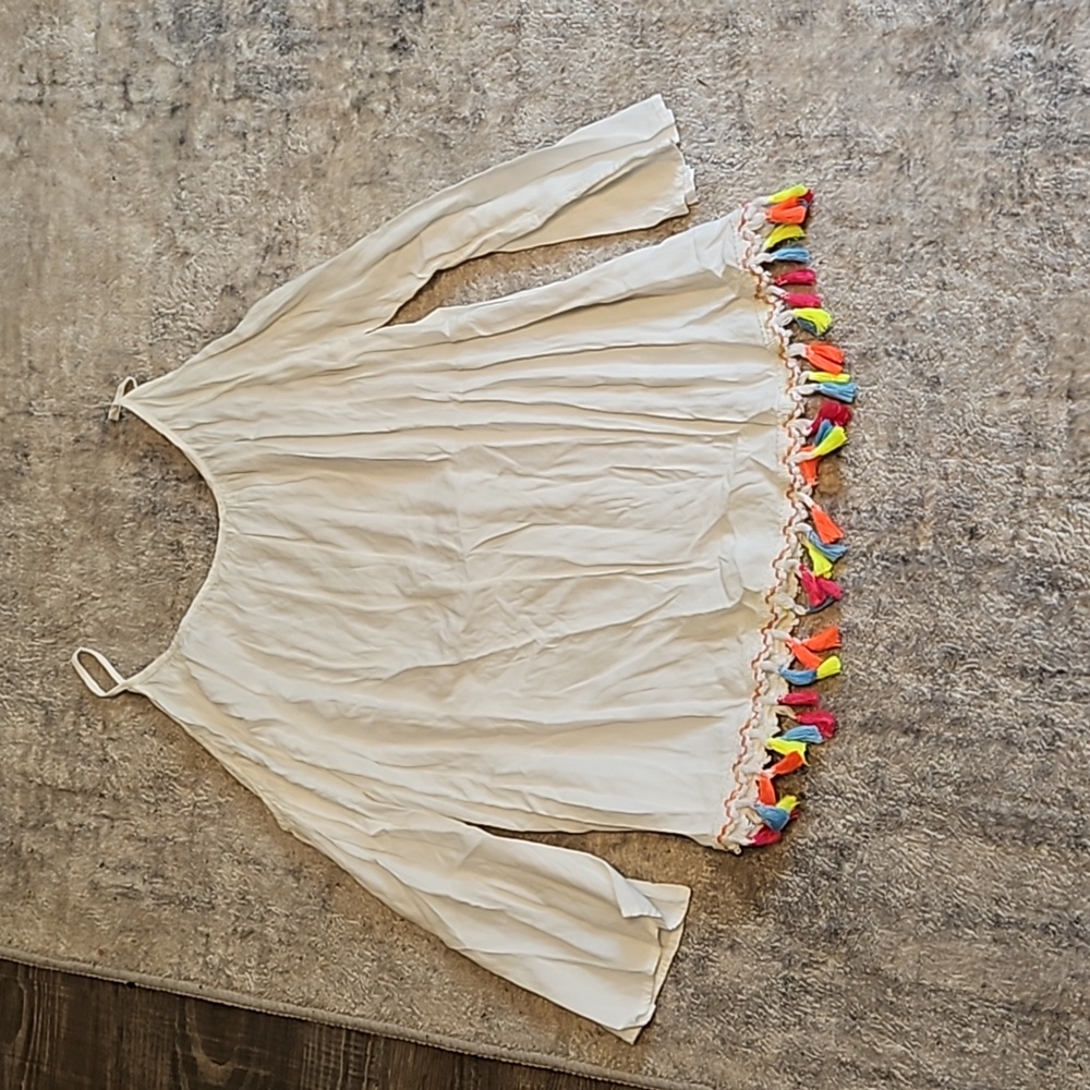 Open shoulder white blouse with tassels